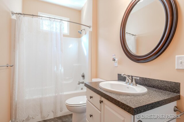 full bathroom featuring shower / bath combination with curtain, toilet, and vanity