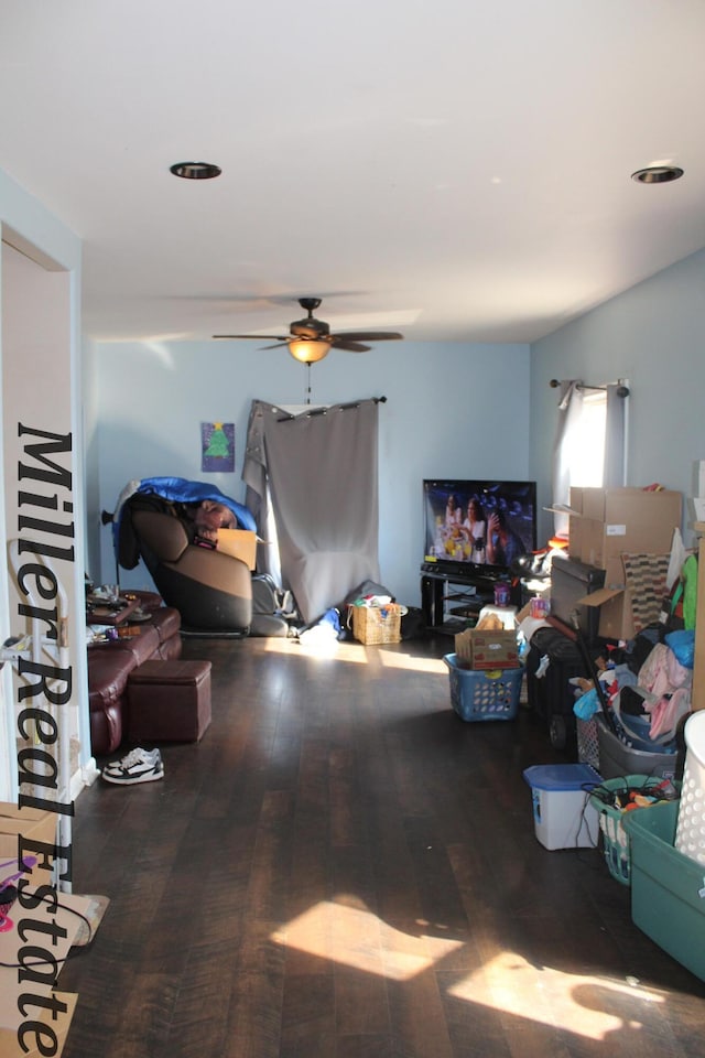 living room with hardwood / wood-style floors and ceiling fan