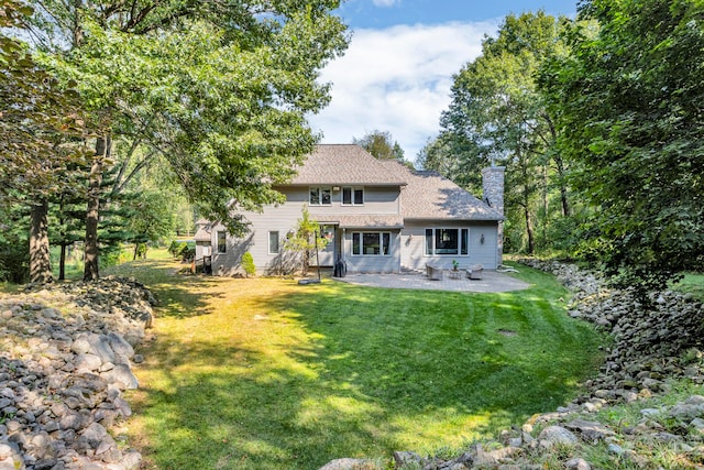 back of property featuring a lawn and a patio