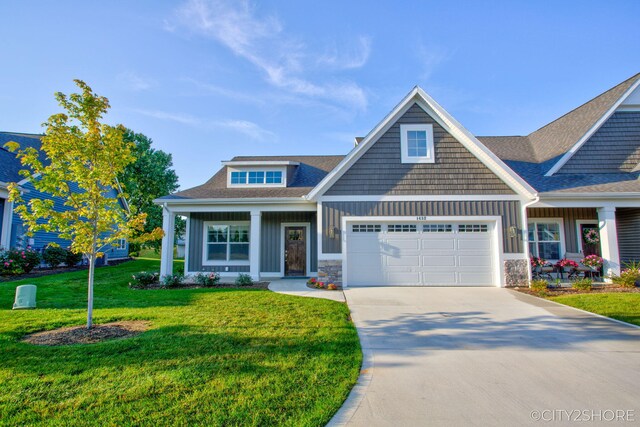 craftsman-style house featuring a front lawn and a garage