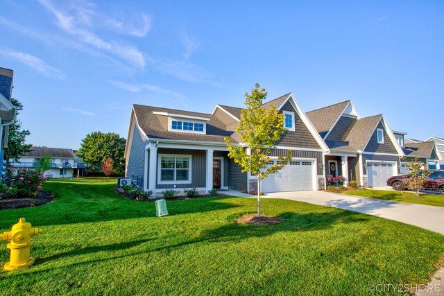 craftsman-style home featuring a front yard and a garage