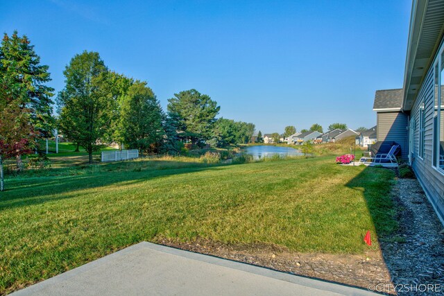 view of yard with a patio area and a water view