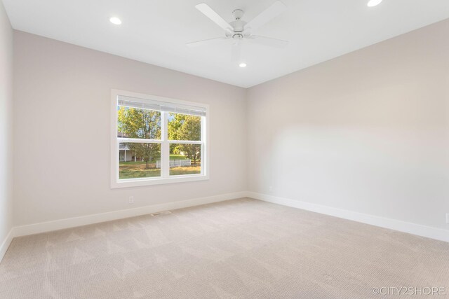 carpeted empty room featuring ceiling fan