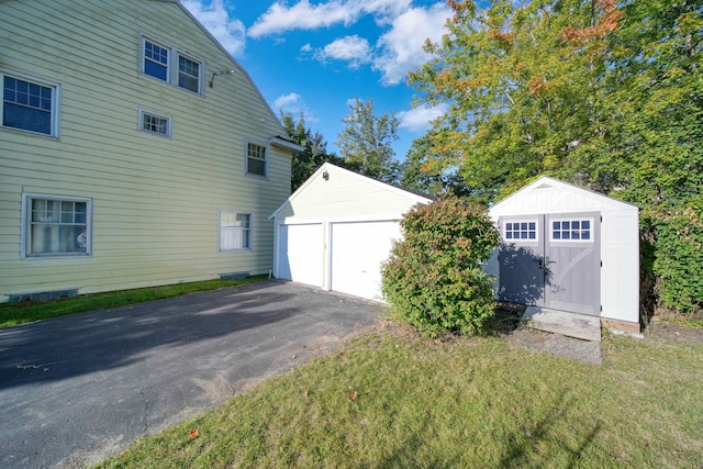 view of home's exterior featuring a storage unit and a lawn