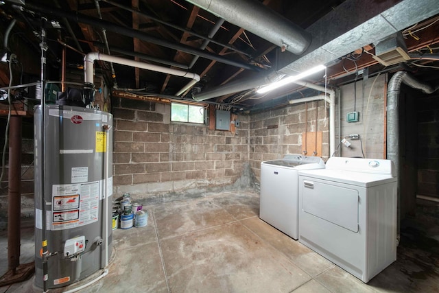 basement featuring gas water heater, electric panel, and washing machine and dryer