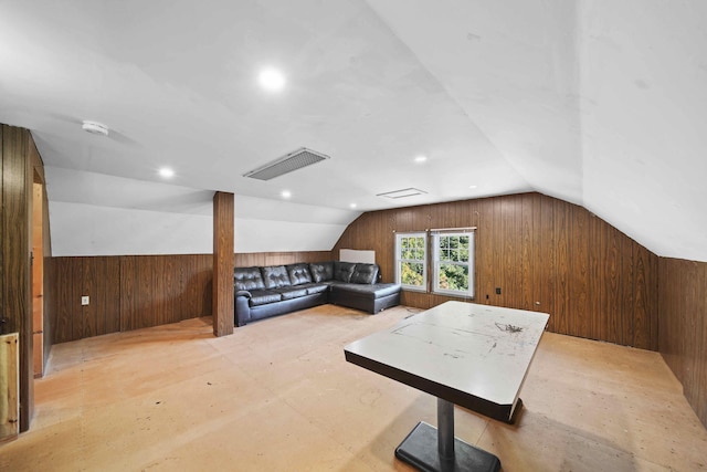 additional living space with vaulted ceiling and wood walls