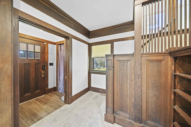 foyer entrance featuring light hardwood / wood-style flooring and ornamental molding