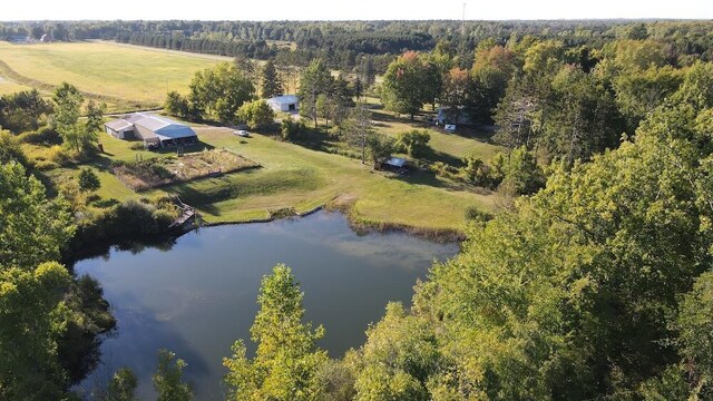 birds eye view of property featuring a water view and a rural view