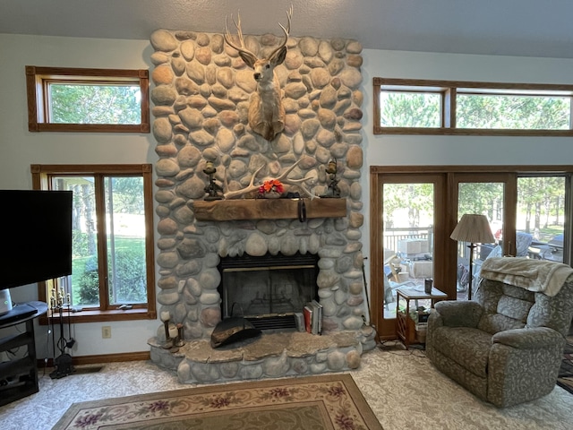 2622 S Sheridan Rd, Caro, MI 48723 - carpeted living room featuring a high ceiling, baseboards, and a fireplace