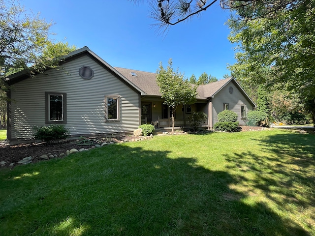 rear view of house featuring a yard