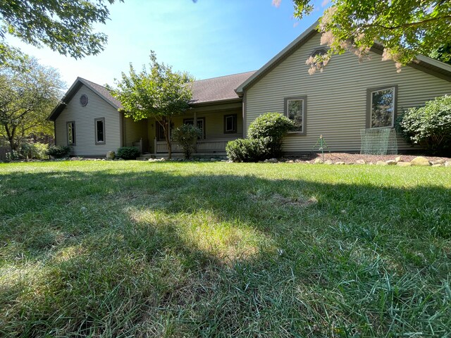 back of property with a lawn