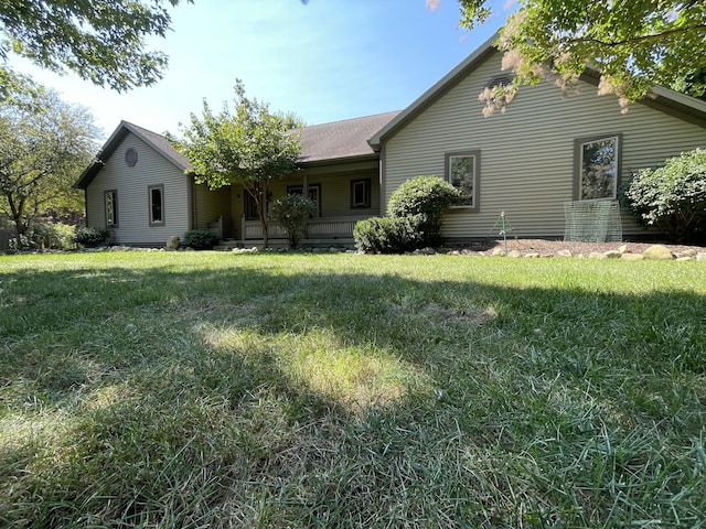 2622 S Sheridan Rd, Caro, MI 48723 - back of house with a shingled roof, covered porch, and a yard