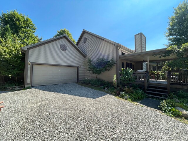 exterior space featuring a garage and a deck