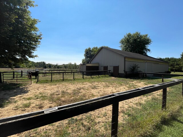 view of yard with a rural view and an outbuilding