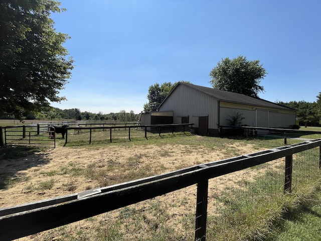 2622 S Sheridan Rd, Caro, MI 48723 - view of yard featuring a pole building, an outbuilding, fence, and a rural view