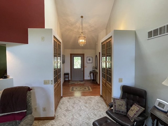 2622 S Sheridan Rd, Caro, MI 48723 - entryway featuring light wood-type flooring, high vaulted ceiling, baseboards, a chandelier, and visible vents