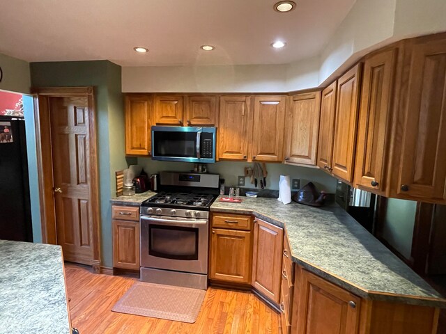 kitchen featuring stainless steel appliances and light wood-type flooring