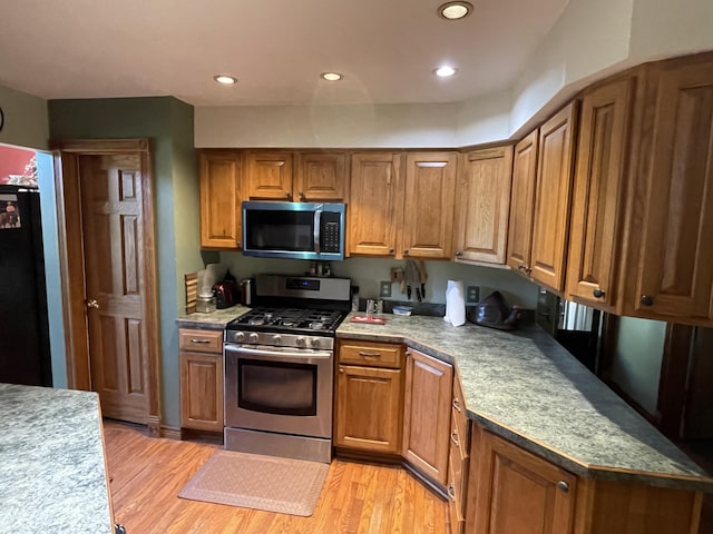 2622 S Sheridan Rd, Caro, MI 48723 - kitchen featuring light wood finished floors, recessed lighting, brown cabinetry, and appliances with stainless steel finishes