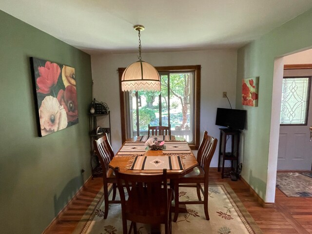 dining area featuring parquet flooring