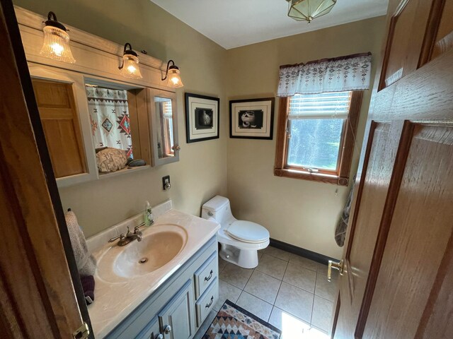 bathroom with tile patterned flooring, vanity, and toilet