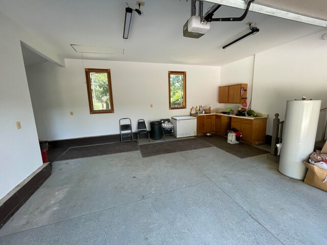 garage with water heater and a garage door opener