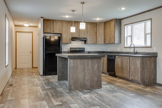 kitchen with black appliances, decorative light fixtures, wood-type flooring, and a center island