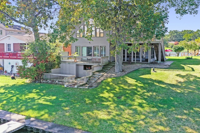 back of house with a yard and a wooden deck