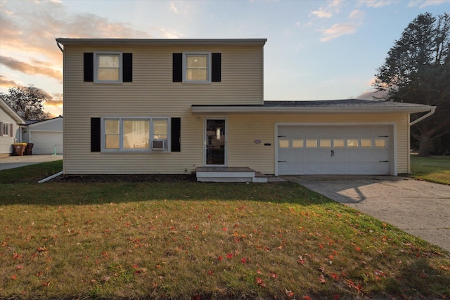 view of front of house with a garage and a yard