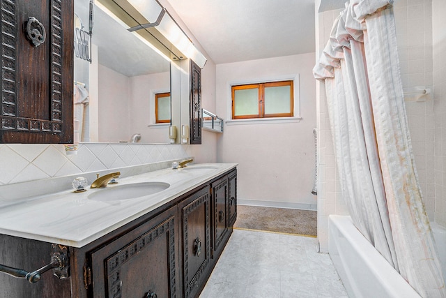 bathroom with backsplash, shower / tub combo with curtain, and vanity