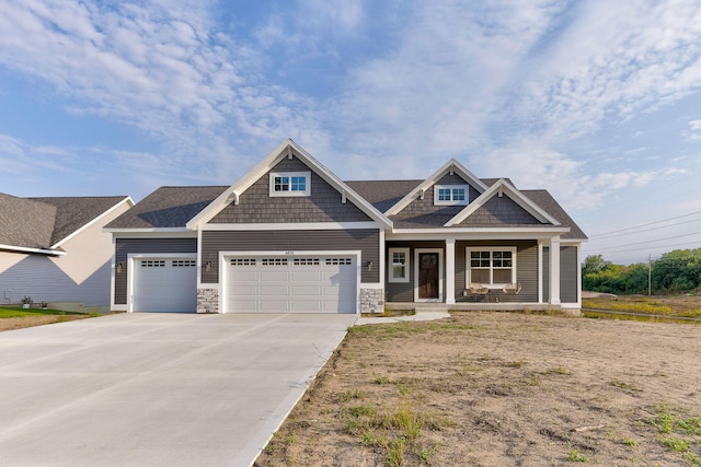 craftsman-style home with a garage and covered porch