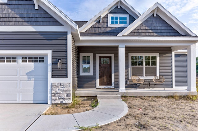 entrance to property featuring a garage and covered porch