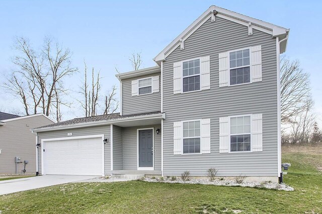 view of front of property featuring a garage and a front lawn