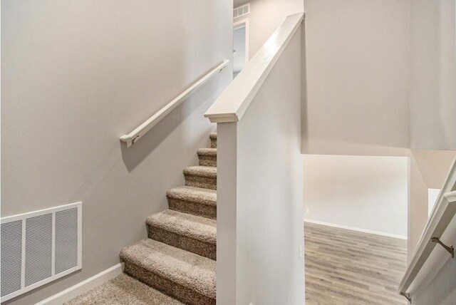 staircase featuring hardwood / wood-style floors