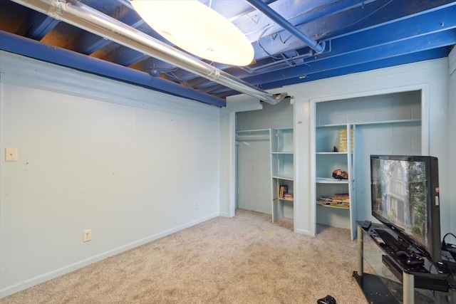 basement featuring light colored carpet