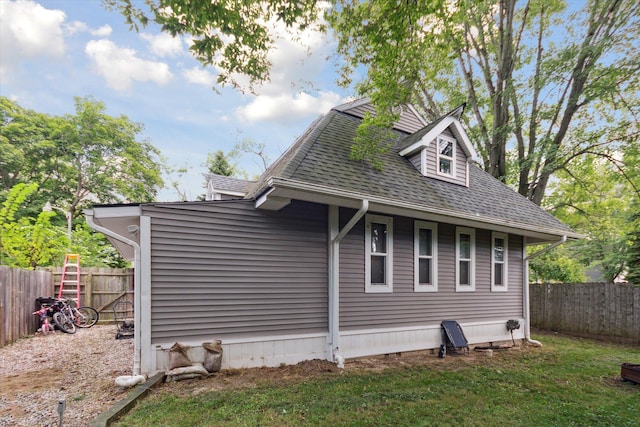 view of side of property with a yard