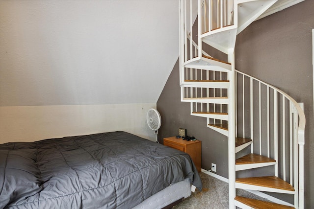 bedroom with lofted ceiling and carpet floors