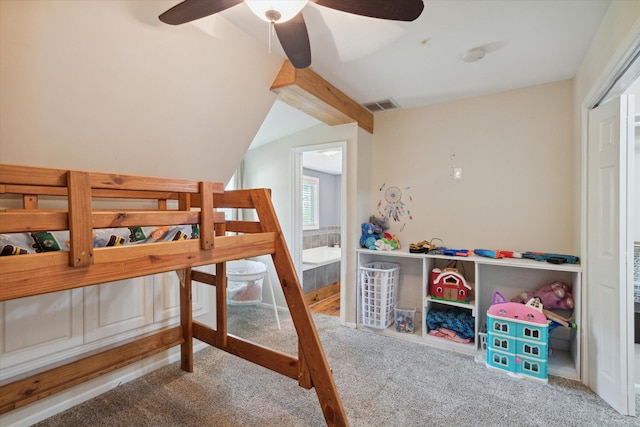 bedroom with carpet, ceiling fan, and beam ceiling