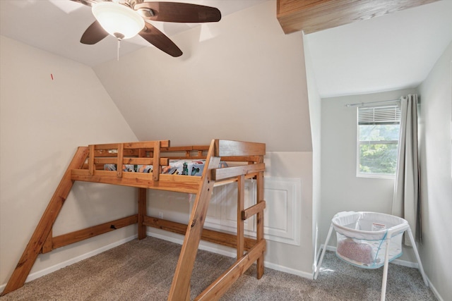 carpeted bedroom with ceiling fan and vaulted ceiling