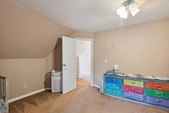 rec room with a textured ceiling, vaulted ceiling, light carpet, and ceiling fan