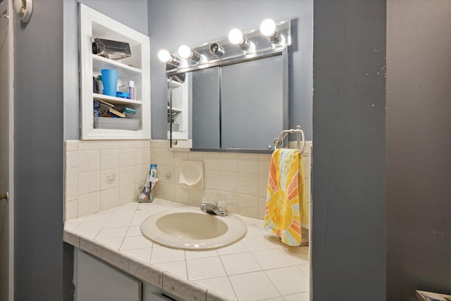 bathroom with vanity and tasteful backsplash