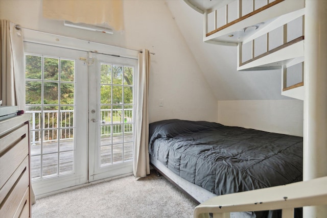 bedroom with lofted ceiling, access to exterior, and light carpet