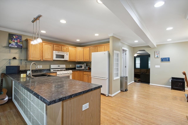 kitchen with pendant lighting, white appliances, light hardwood / wood-style flooring, kitchen peninsula, and sink