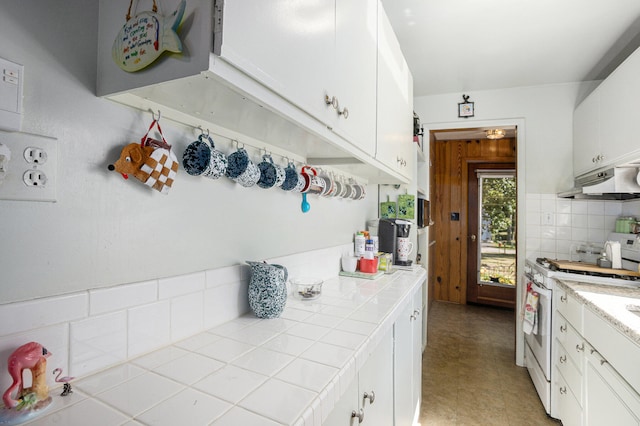 kitchen with tile countertops, white gas stove, decorative backsplash, and white cabinetry