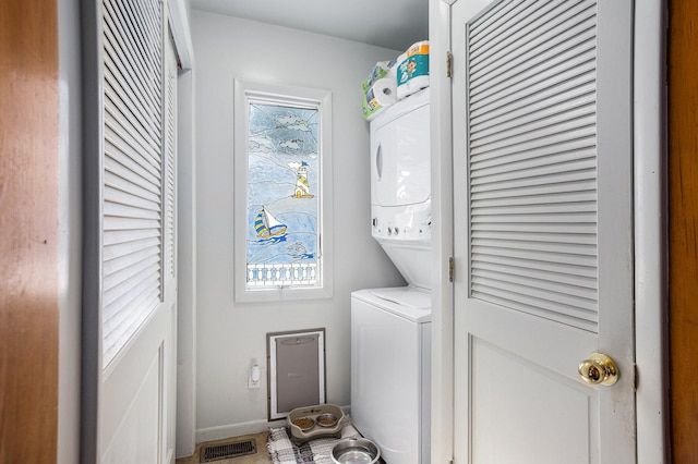 washroom with stacked washer and clothes dryer