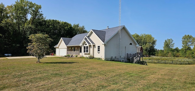 view of side of property with a lawn and a garage