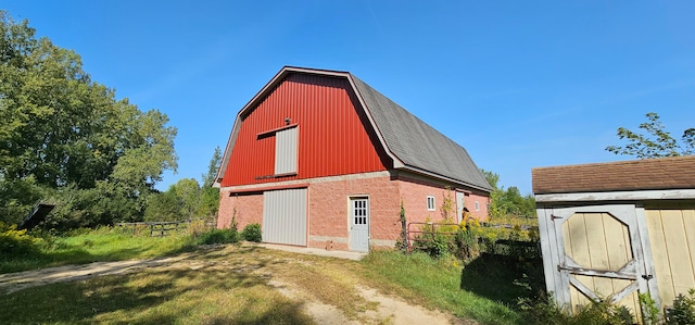 view of property exterior with a storage unit