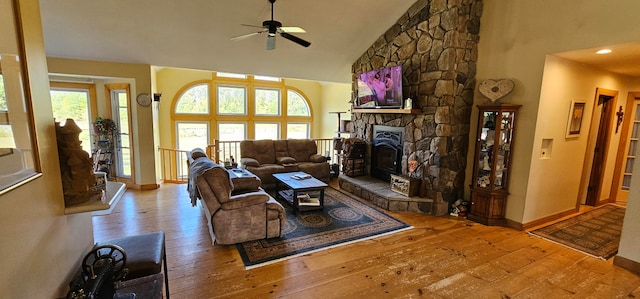 living room with wood-type flooring, ceiling fan, and a wealth of natural light