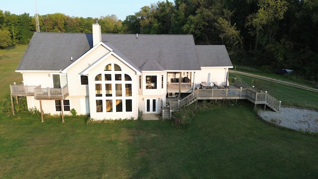 back of property featuring a yard and a wooden deck