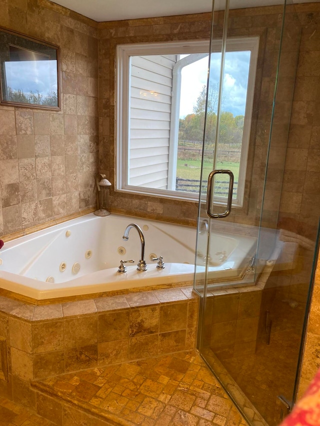 bathroom featuring independent shower and bath