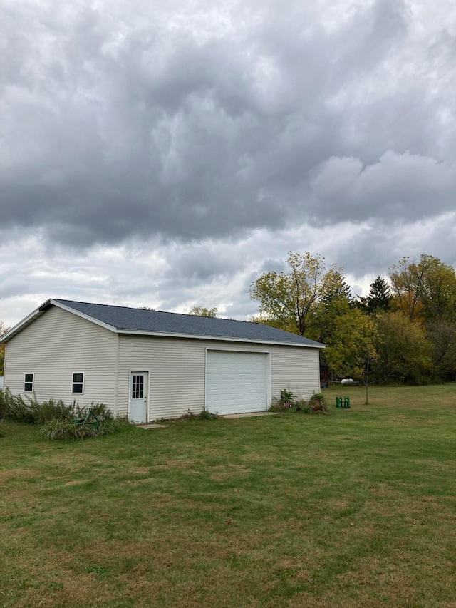 garage featuring a yard